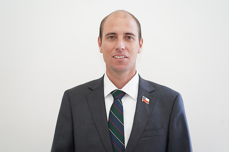 Chris standing up holding his daughter Elva